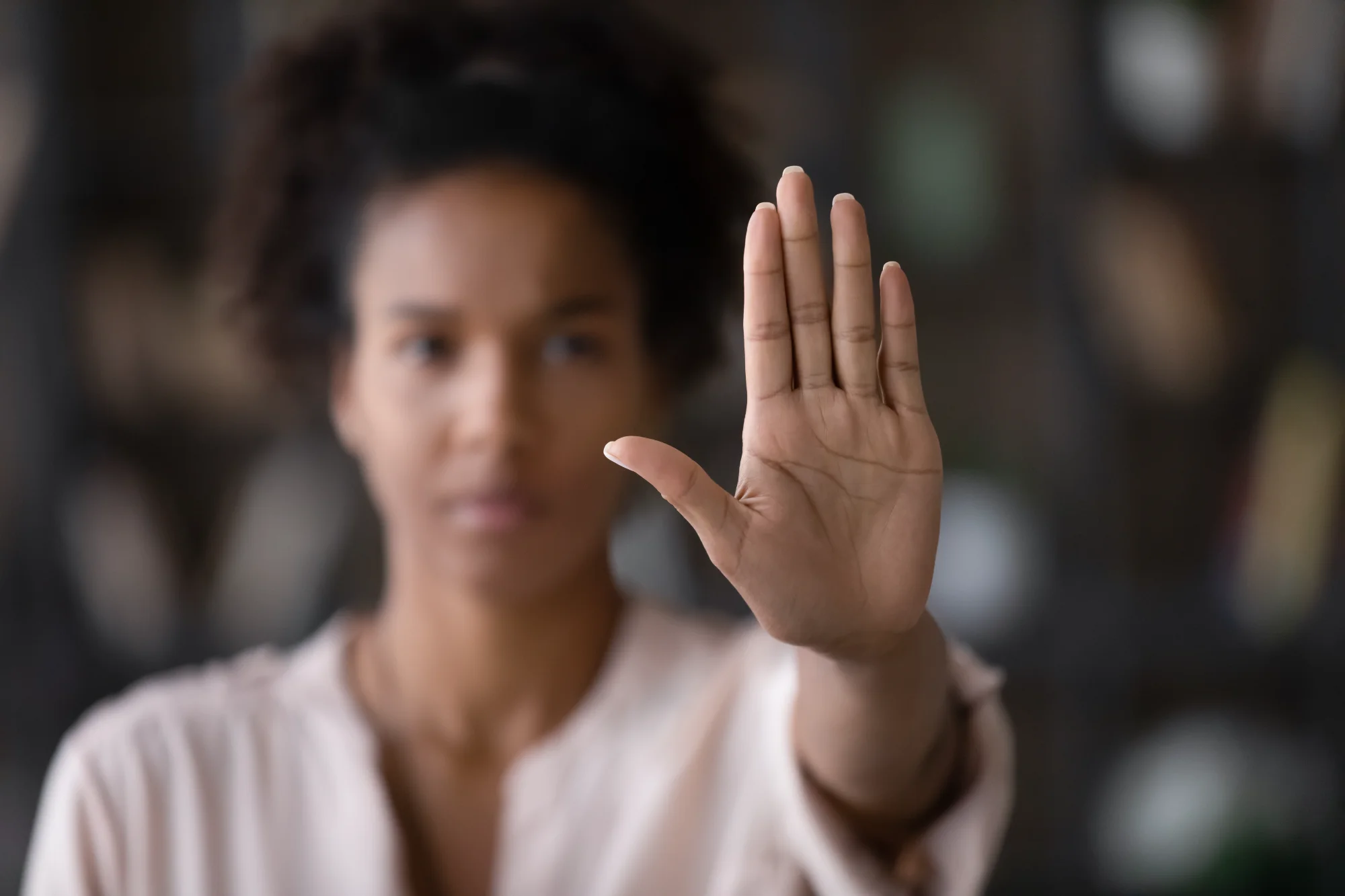 Woman with hand raised in a clear stop gesture